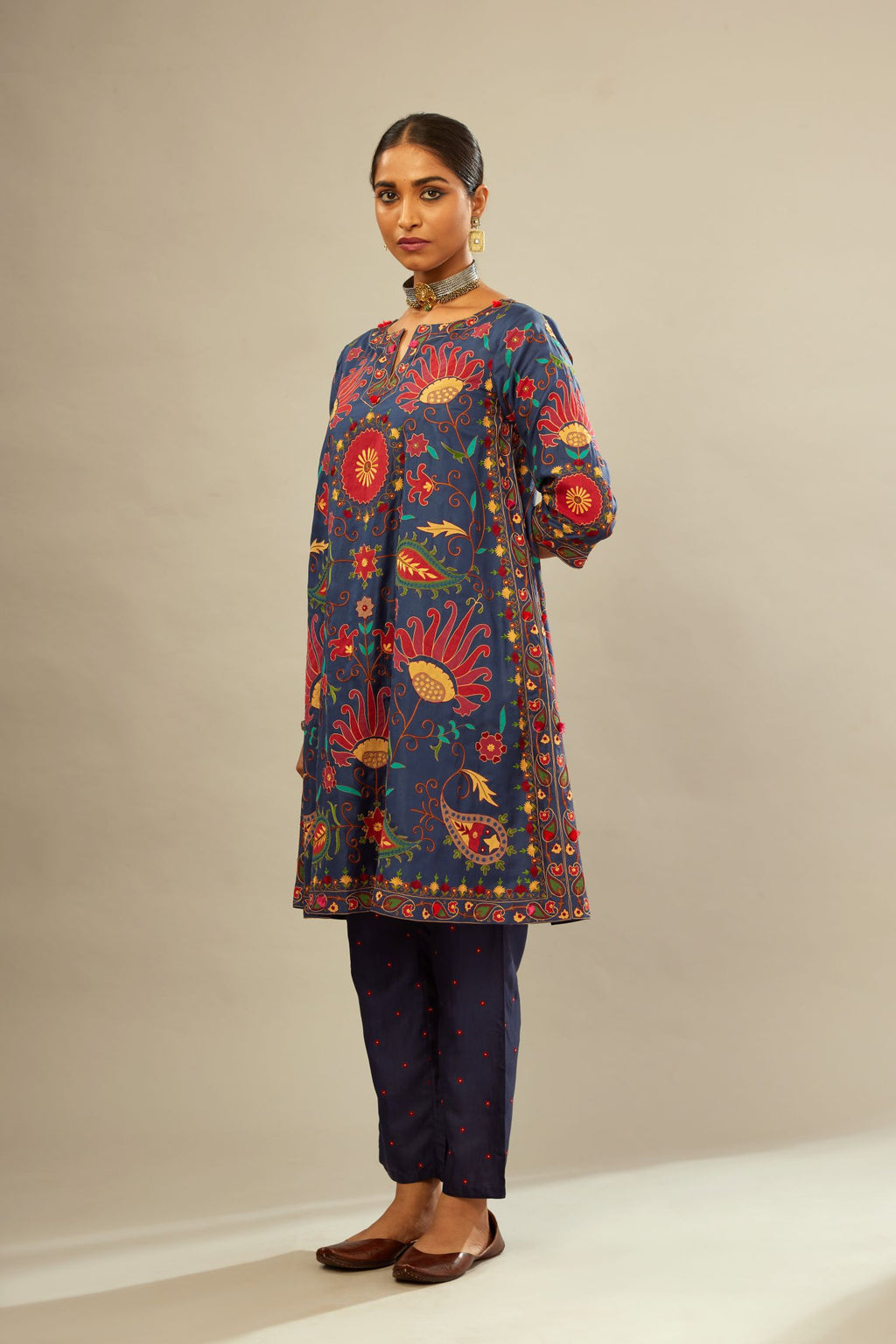 Indigo short A-line silk kurta set, fully embroidered with multi colored appliqué with aari thread work and silk tassels.