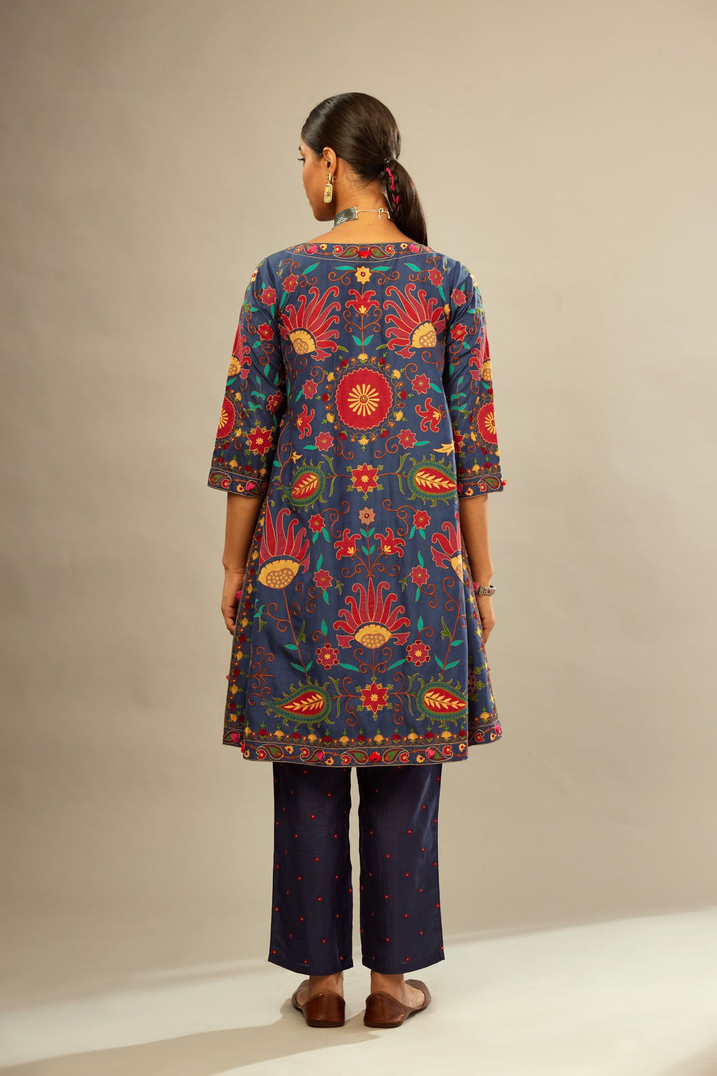 Indigo short A-line silk kurta set, fully embroidered with multi colored appliqué with aari thread work and silk tassels.