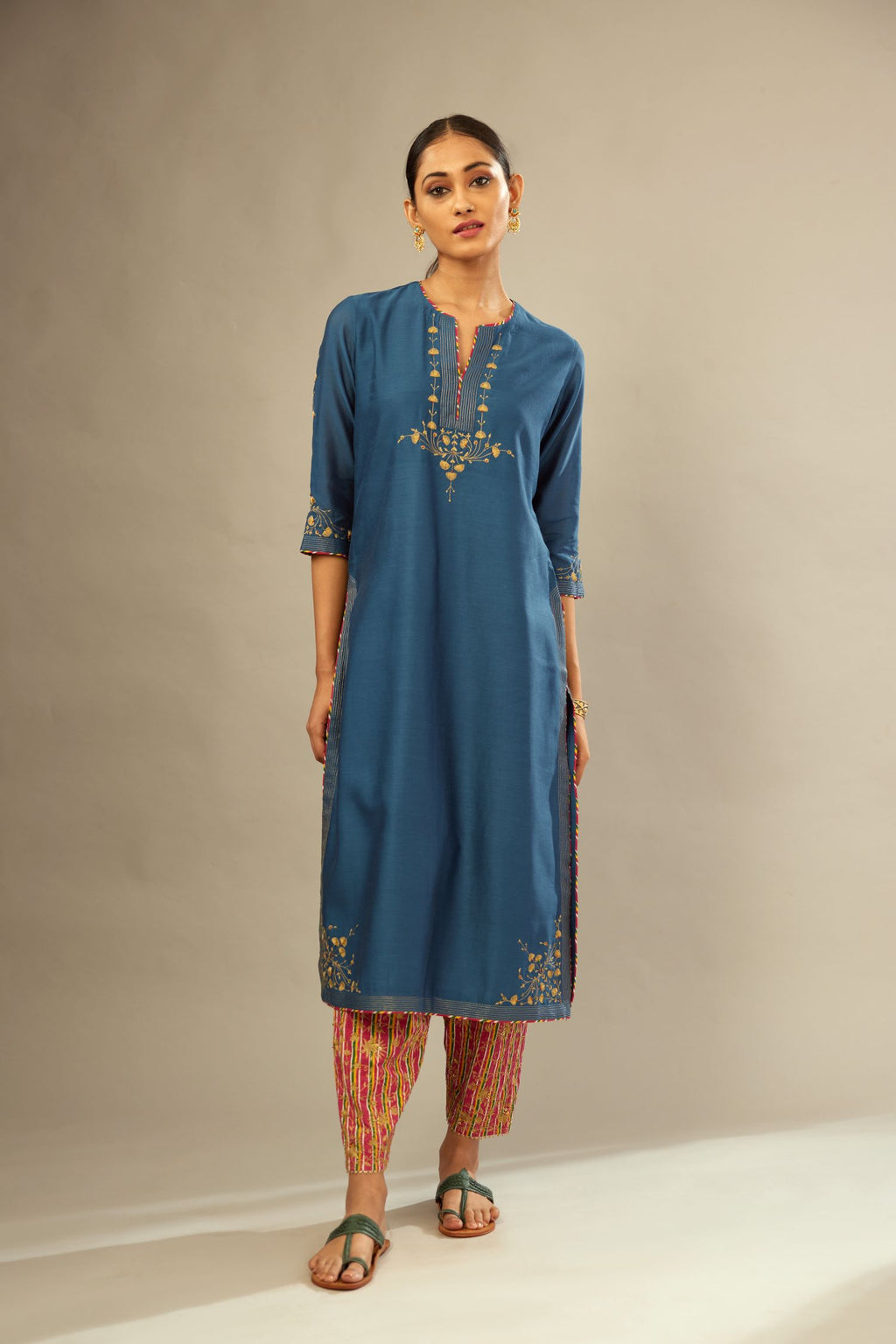 Teal blue silk Chanderi kurta set with zari embroidery, highlighted with golden zari quilting