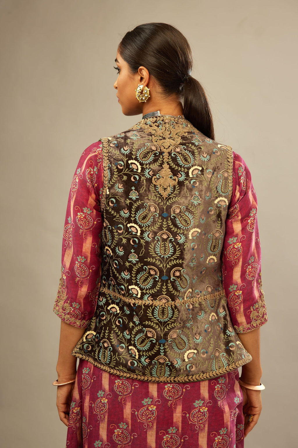 Short stone-grey front open silk-velvet gilet with all over aari thread work highlighted with antique gold embroidery.