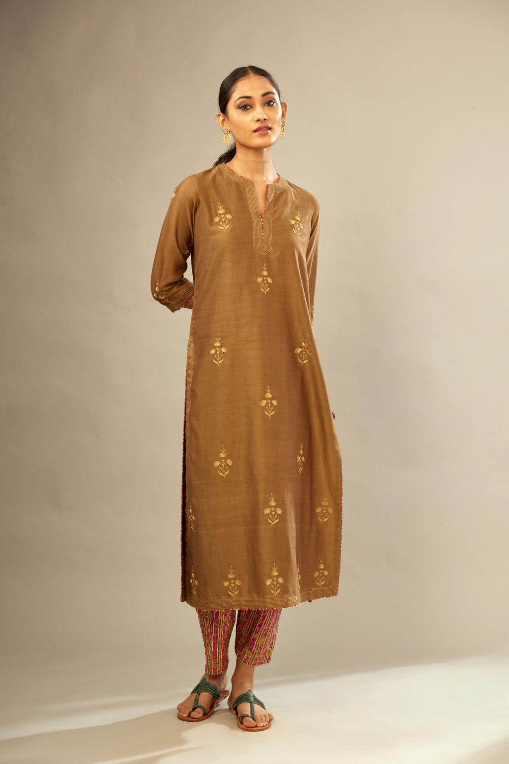 Olive silk chanderi kurta set with golden zari embroidery bootas all over the kurtaand quilted edges.