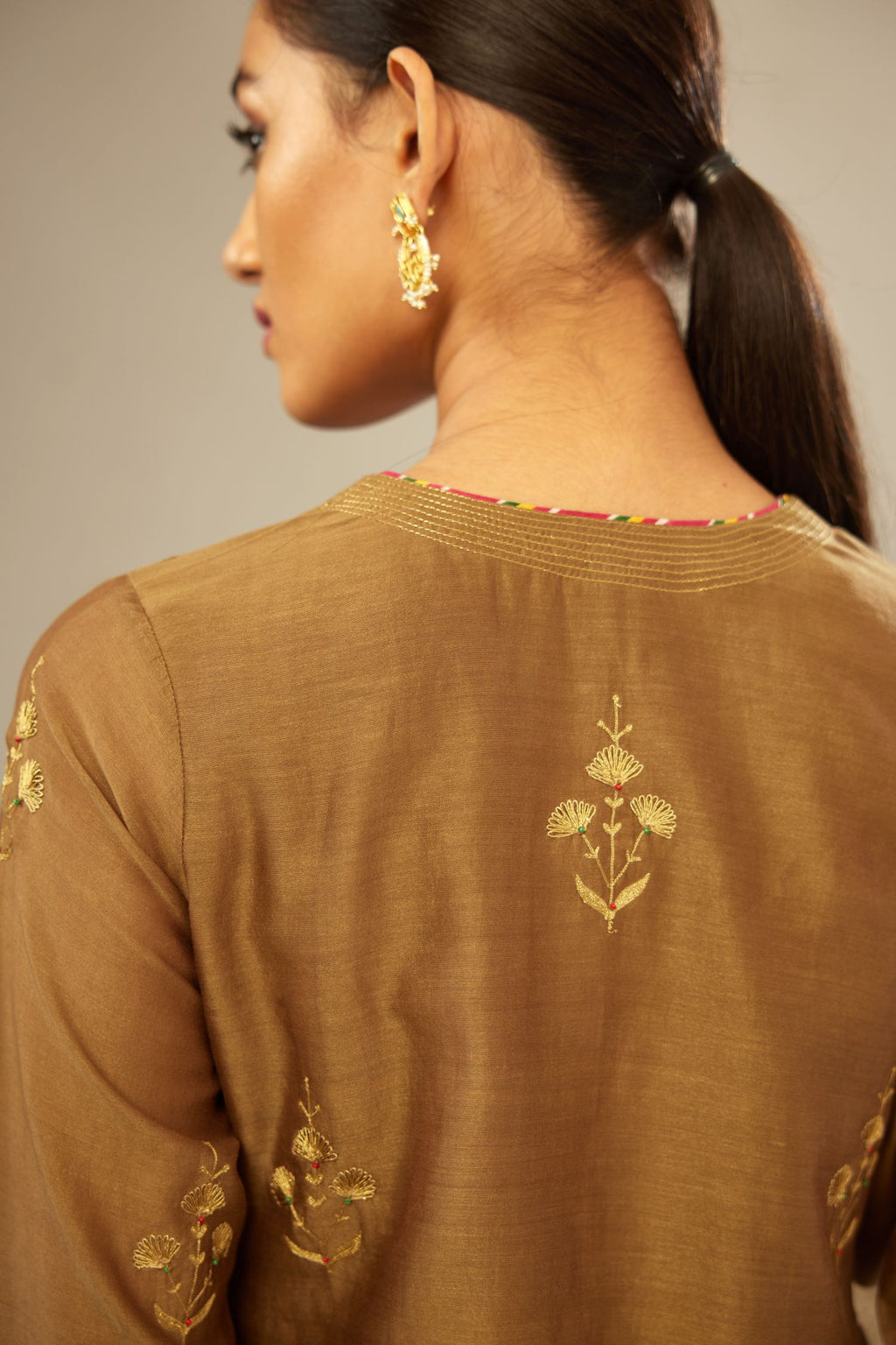 Olive silk chanderi kurta set with golden zari embroidery bootas all over the kurtaand quilted edges.