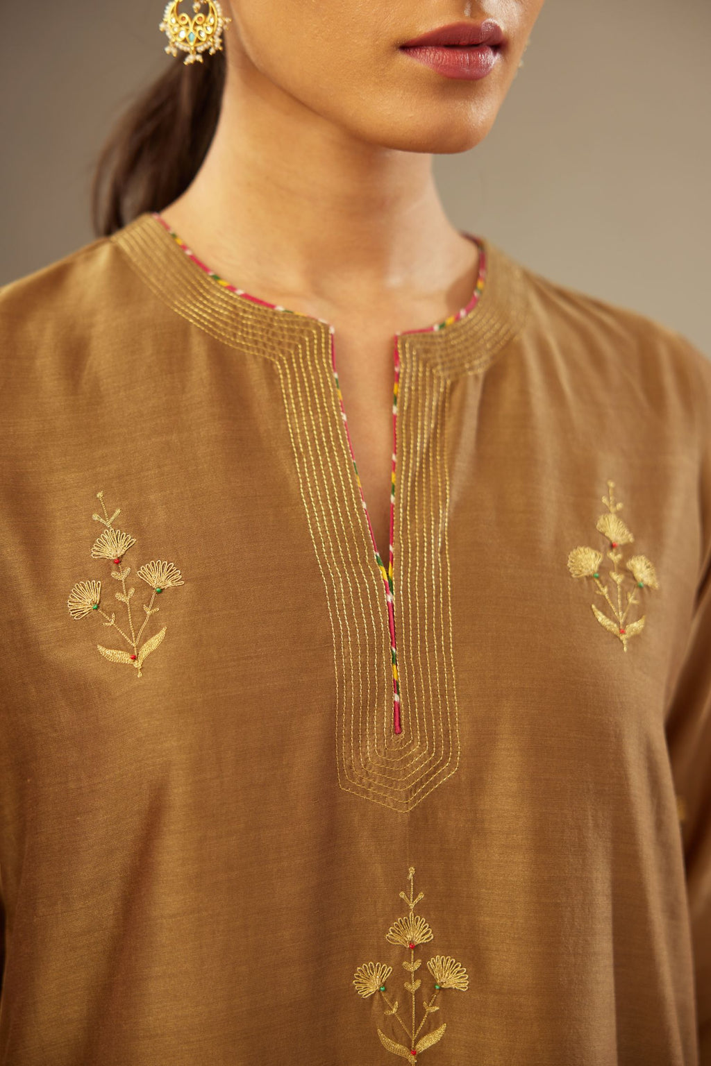 Olive silk chanderi kurta set with golden zari embroidery bootas all over the kurtaand quilted edges.