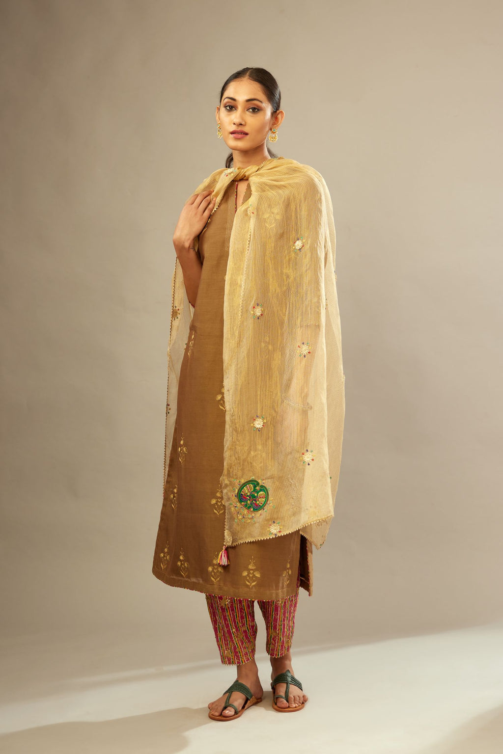 Olive silk chanderi kurta set with golden zari embroidery bootas all over the kurtaand quilted edges.
