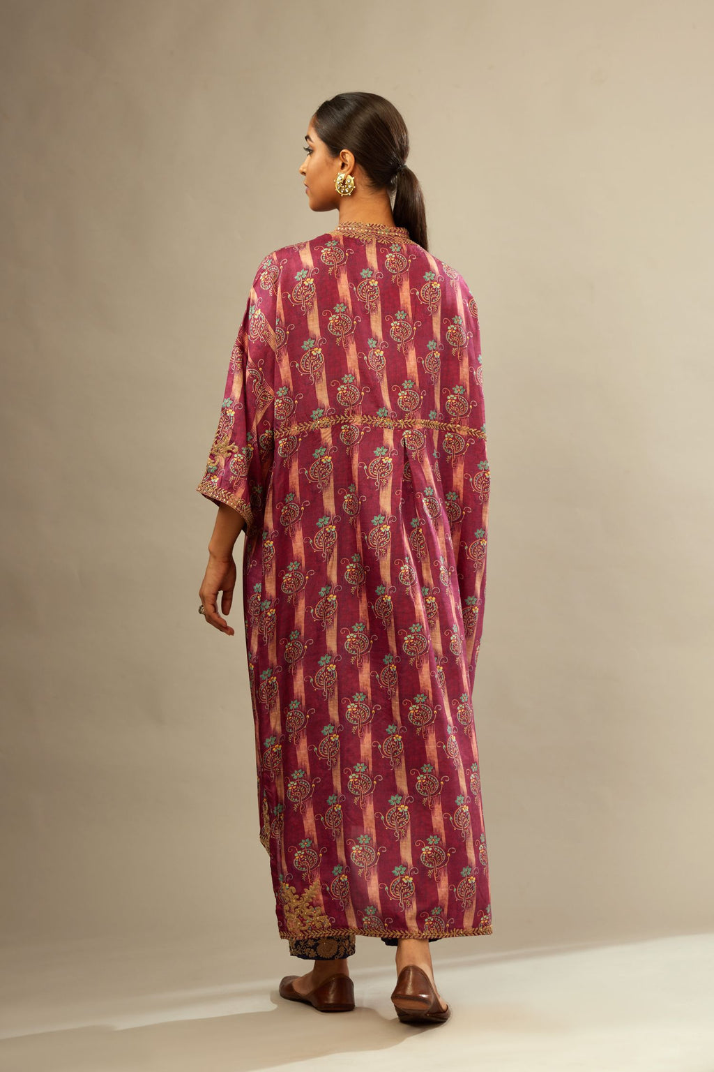 Deep wine digital printed dori embroidered free size silk kaftan, highlighted with gold sequin handwork. Paired with navy blue fine silk straight pants with heavy golden zari and dori embroidery at bottom.