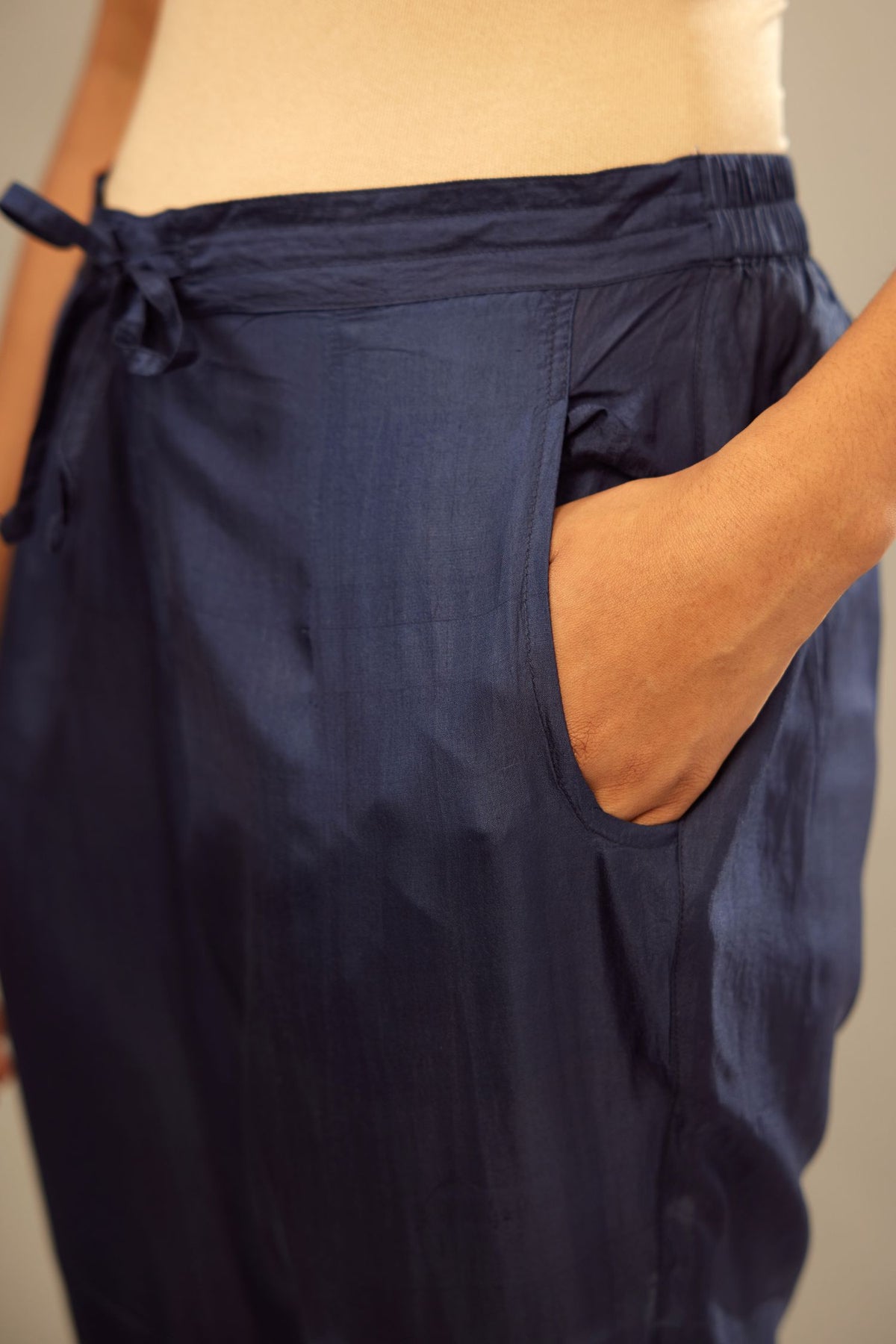 Navy blue fine silk straight pants with heavy golden zari and dori embroidery at bottom.