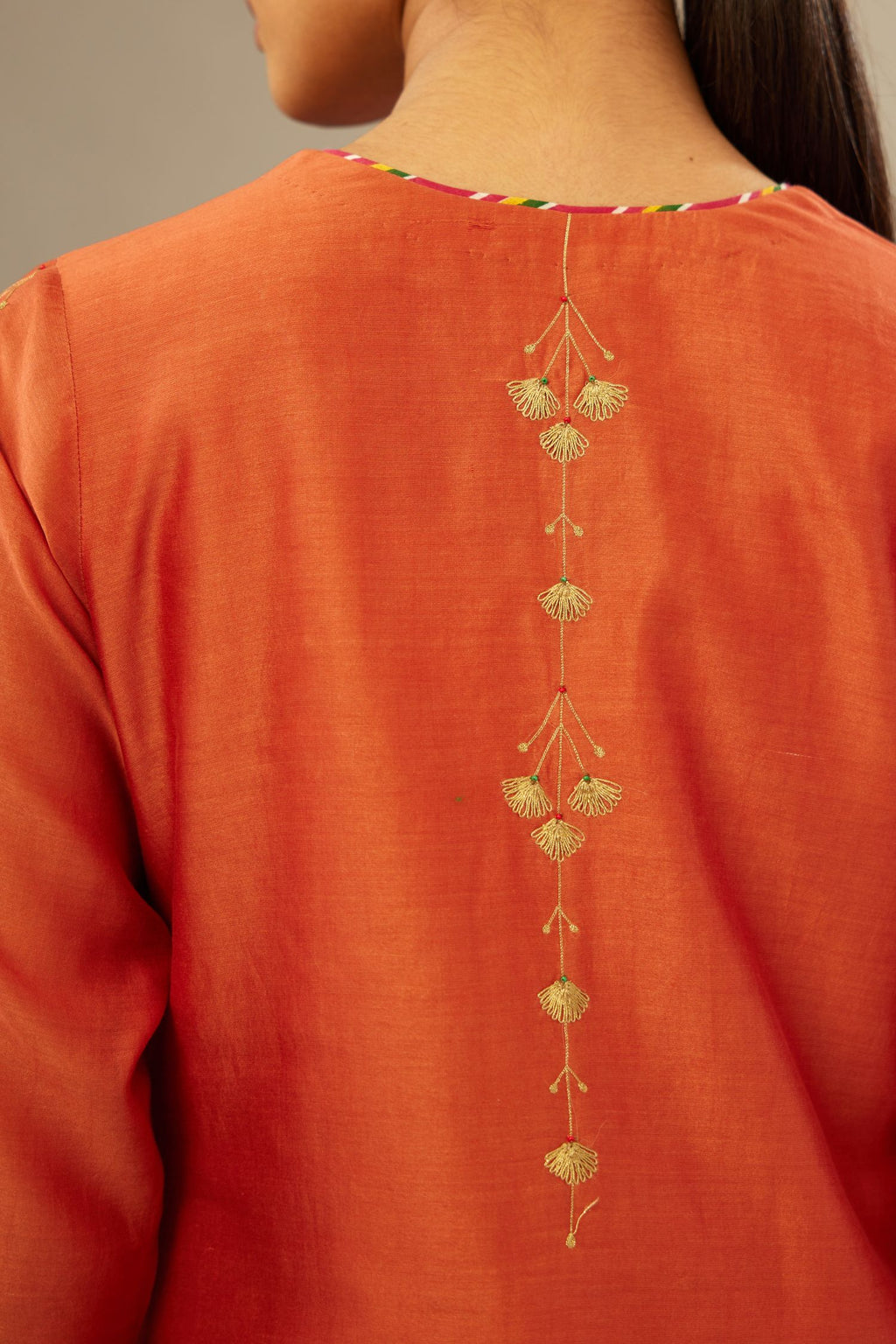 Silk Chanderi straight kurta set detailed with golden zari and multi striped piping on the edges.
