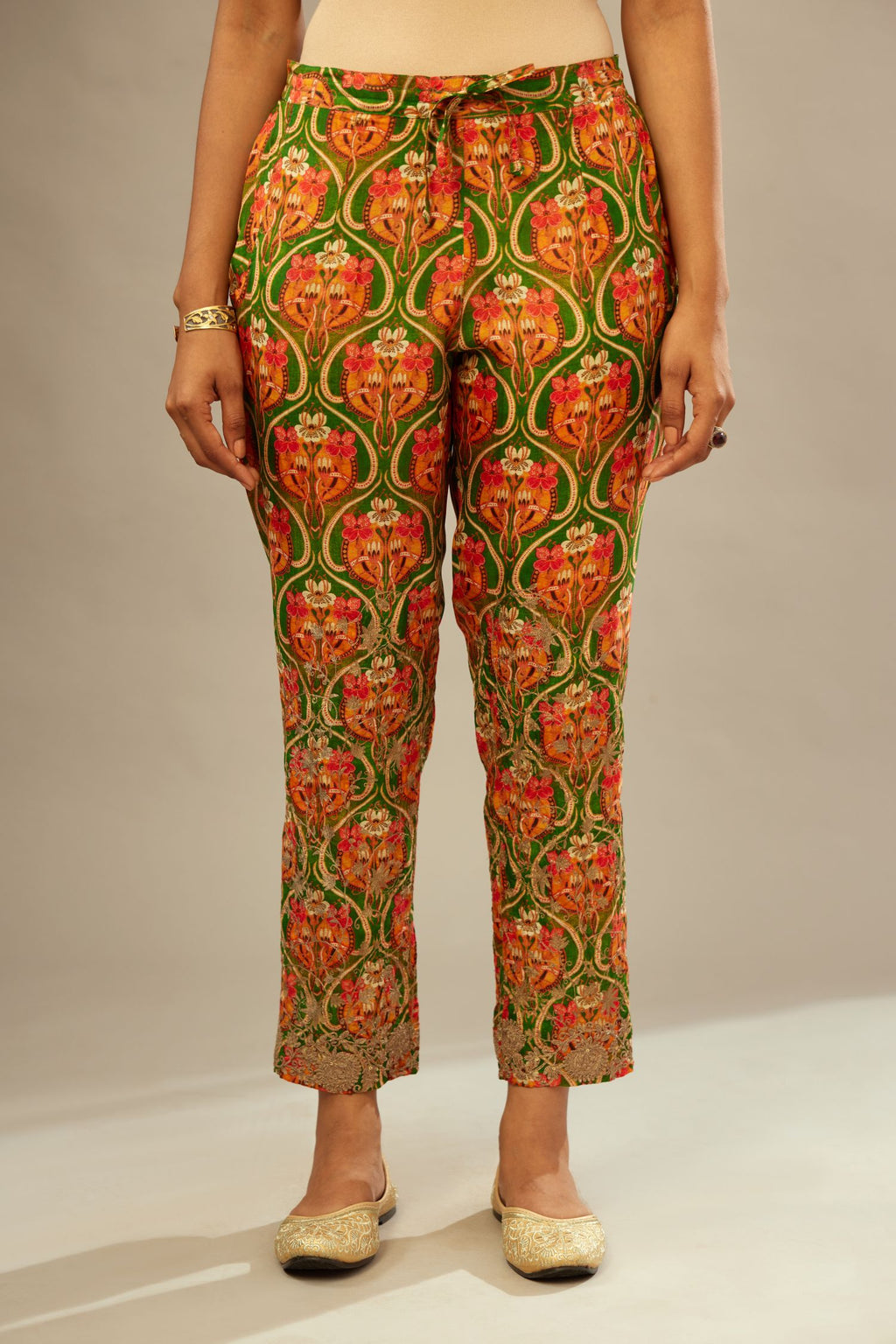 Green digital printed fine silk straight pants with heavy golden zari and dori embroidery at bottom.