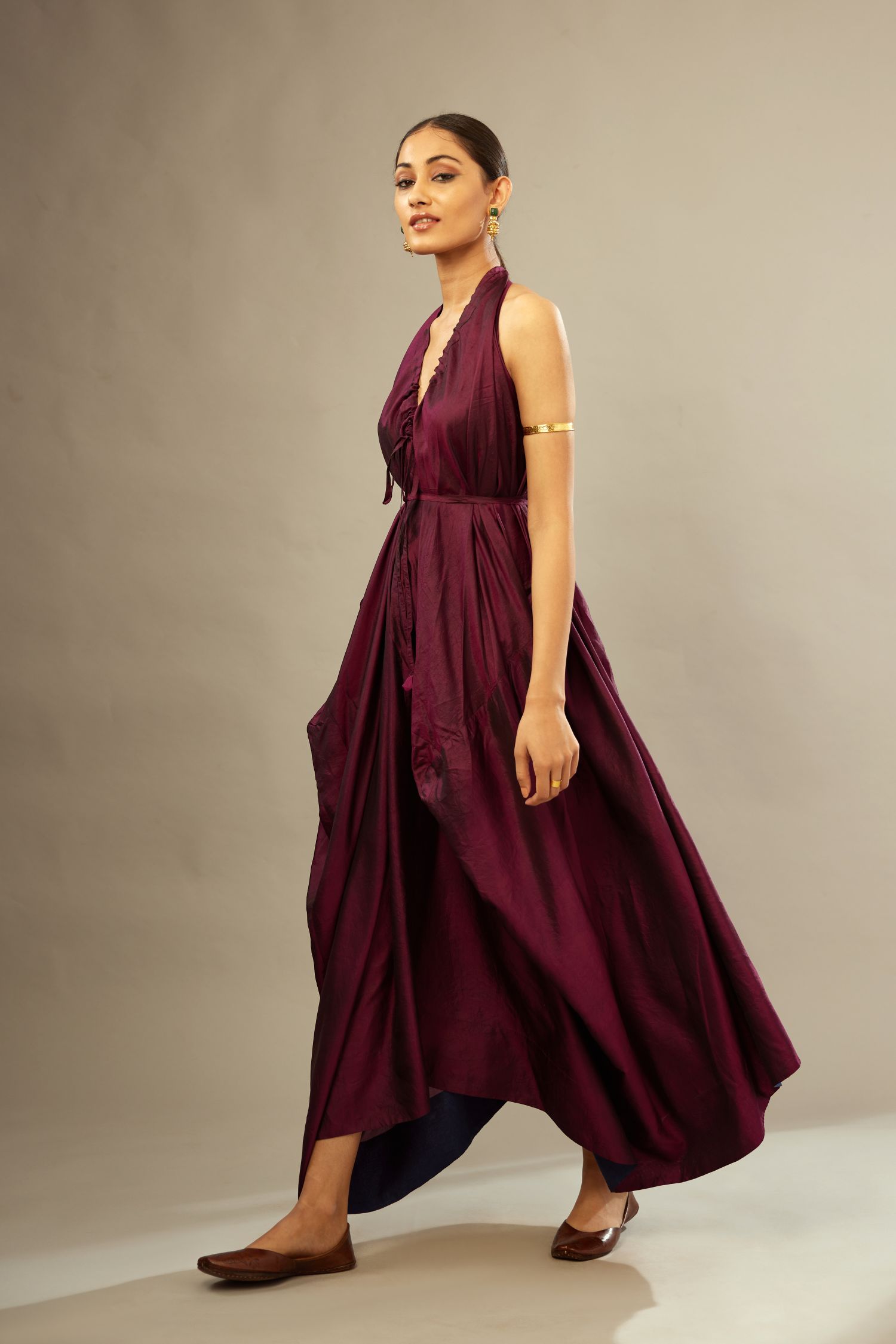 Wine silk long free size dress with asymmetric hem and side pockets, paired with navy blue silk velvet short jacket with light gold dori embroidery all-over the jacket.