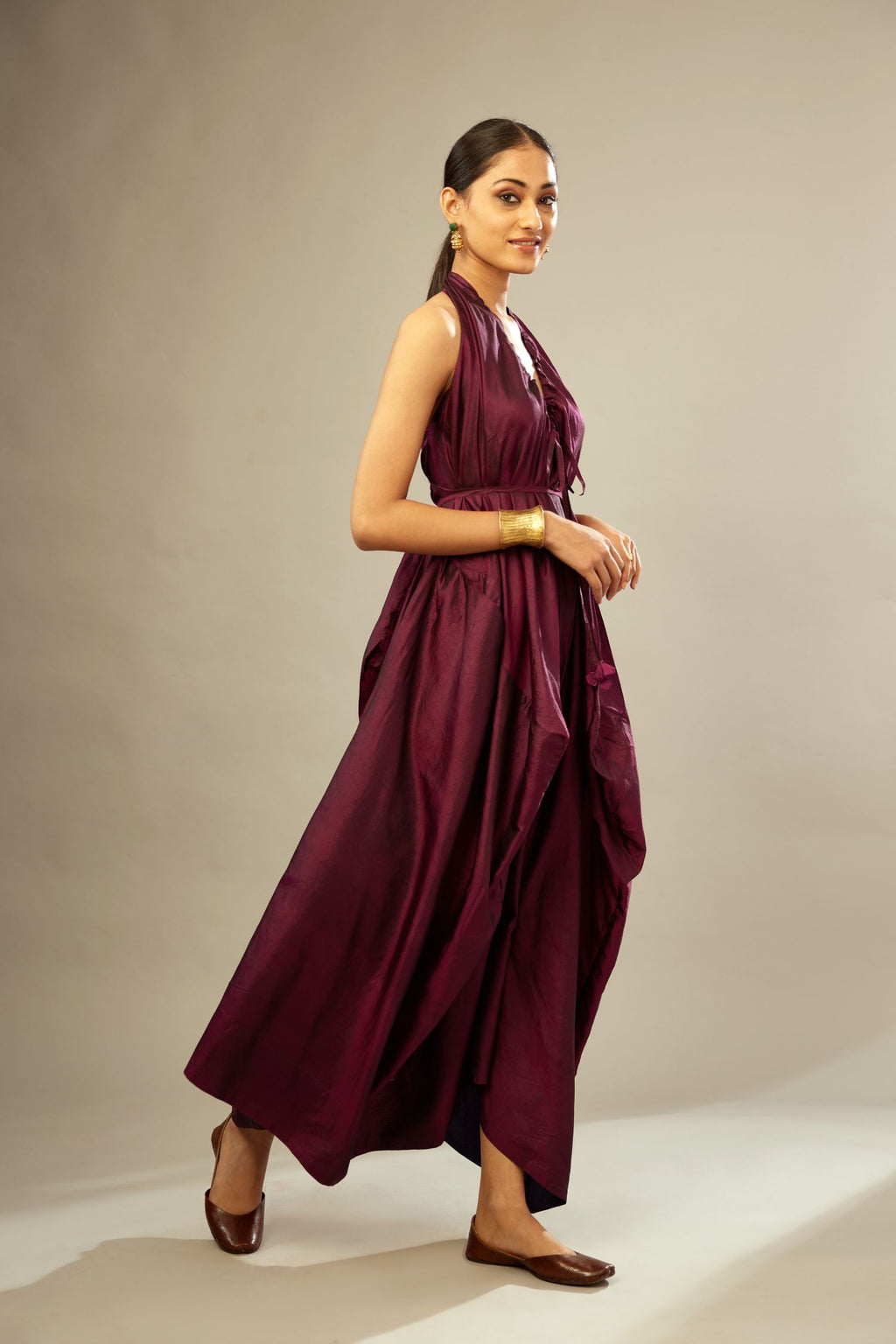 Wine silk long free size dress with asymmetric hem and side pockets, paired with navy blue silk velvet short jacket with light gold dori embroidery all-over the jacket.