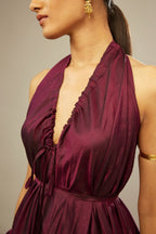 Wine silk long free size dress with asymmetric hem and side pockets, paired with navy blue silk velvet short jacket with light gold dori embroidery all-over the jacket.
