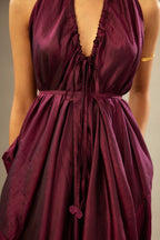 Wine silk long free size dress with asymmetric hem and side pockets, paired with navy blue silk velvet short jacket with light gold dori embroidery all-over the jacket.