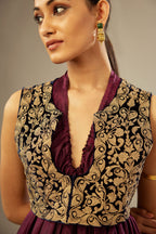 Wine silk long free size dress with asymmetric hem and side pockets, paired with navy blue silk velvet short jacket with light gold dori embroidery all-over the jacket.
