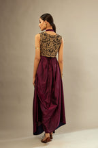 Wine silk long free size dress with asymmetric hem and side pockets, paired with navy blue silk velvet short jacket with light gold dori embroidery all-over the jacket.