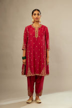 Fuchsia silk chanderi short kalidar kurta set with all-over delicate zari bootis, detailed with dori embroidery and gold sequin work.