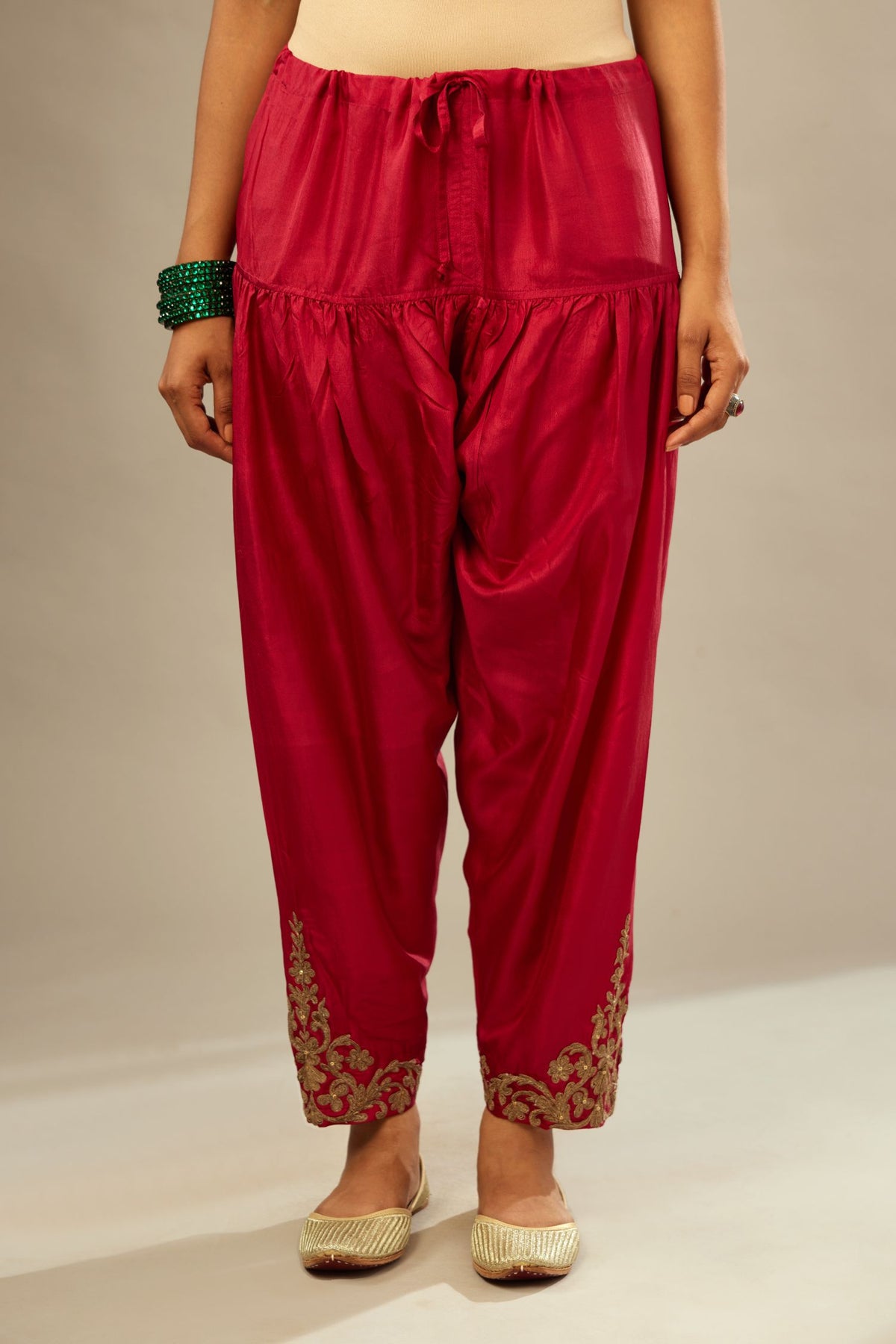 Fuchsia silk narrow salwar with light gold dori embroidery at hem.