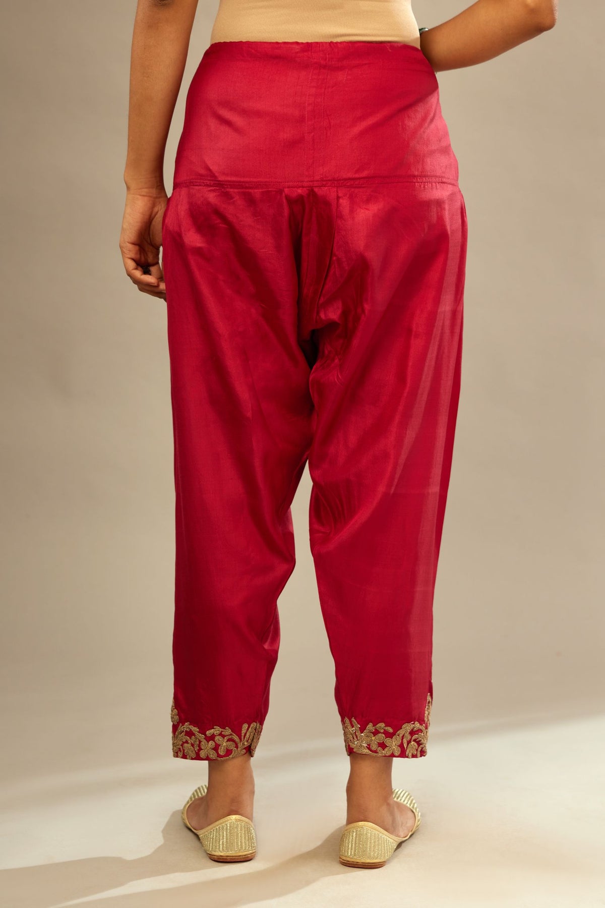 Fuchsia silk narrow salwar with light gold dori embroidery at hem.