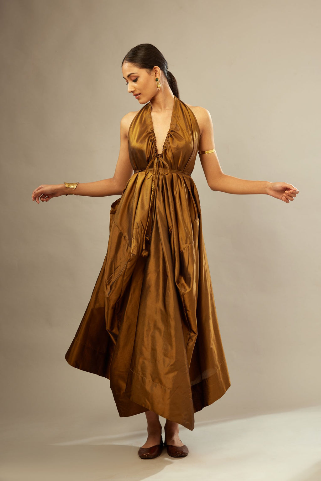 Golden olive silk long free size dress with asymmetric hem and side pockets, paired with navy blue silk velvet short jacket with light gold dori embroidery all-over the jacket.