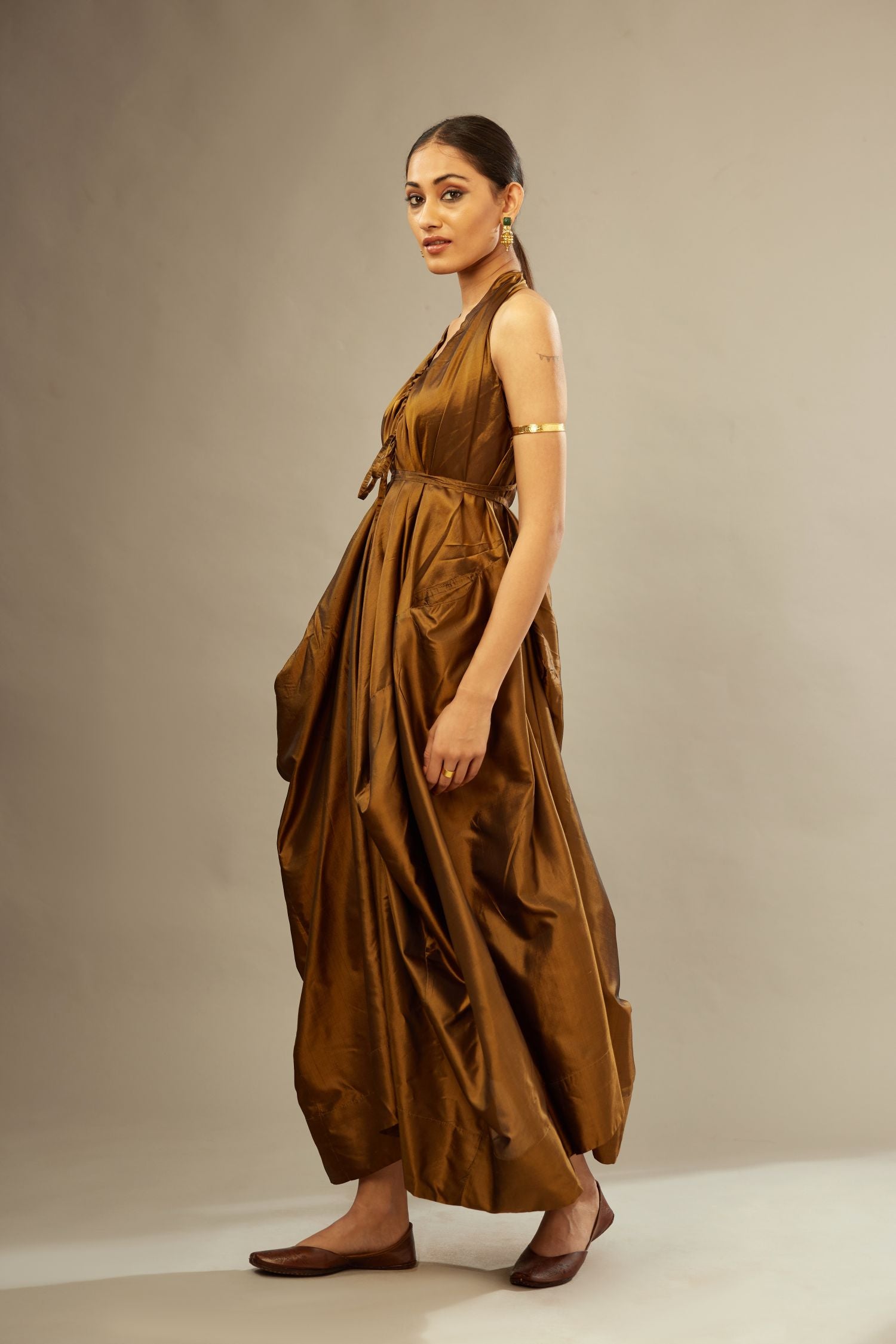 Golden olive silk long free size dress with asymmetric hem and side pockets, paired with navy blue silk velvet short jacket with light gold dori embroidery all-over the jacket.