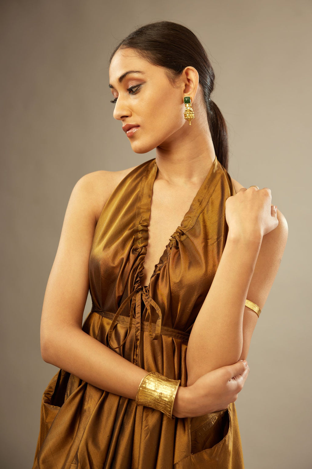 Golden olive silk long free size dress with asymmetric hem and side pockets, paired with navy blue silk velvet short jacket with light gold dori embroidery all-over the jacket.