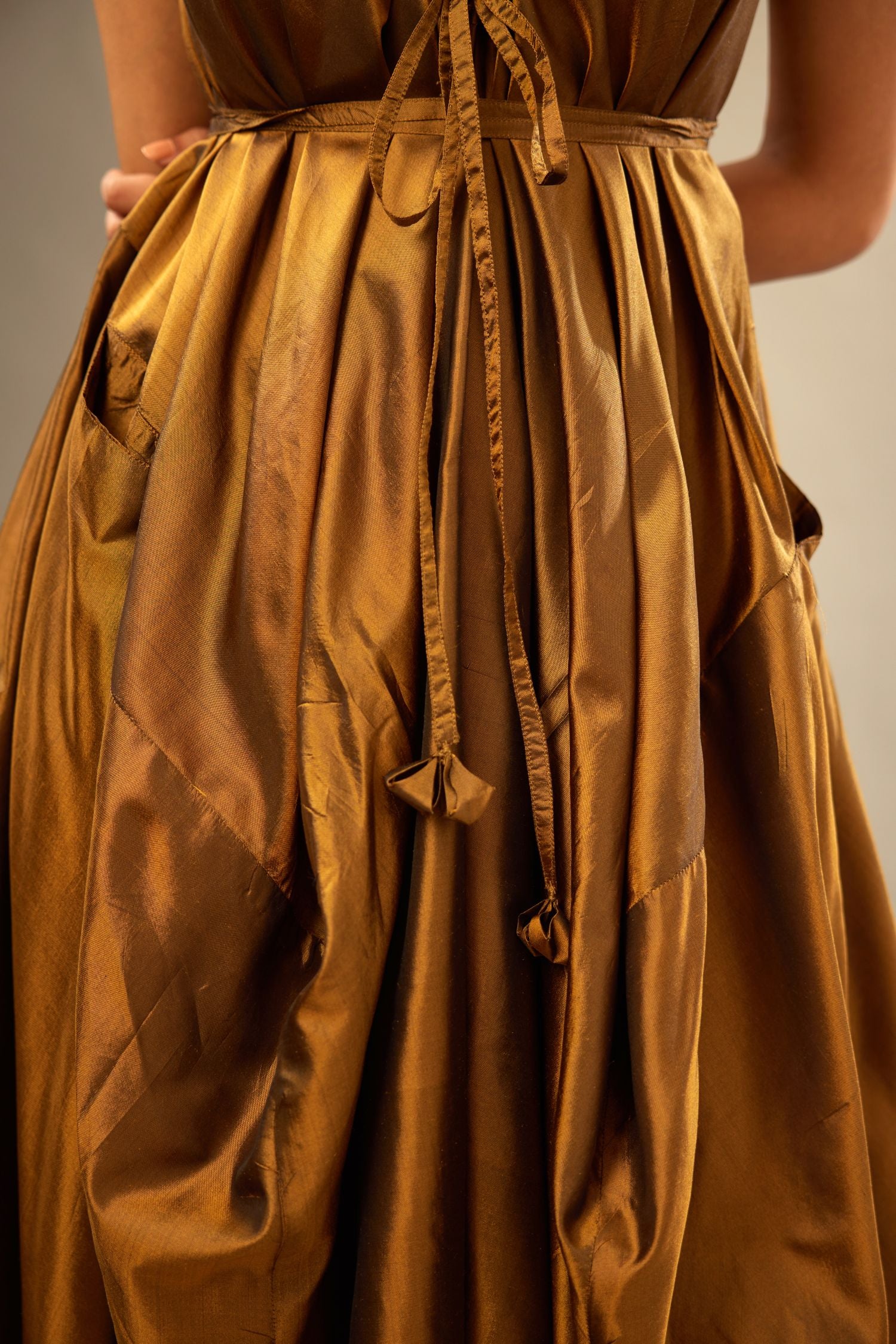 Golden olive silk long free size dress with asymmetric hem and side pockets, paired with navy blue silk velvet short jacket with light gold dori embroidery all-over the jacket.