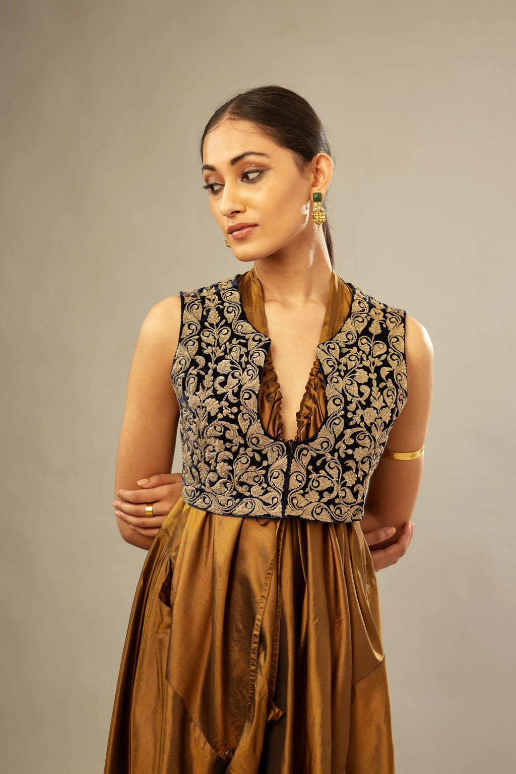 Golden olive silk long free size dress with asymmetric hem and side pockets, paired with navy blue silk velvet short jacket with light gold dori embroidery all-over the jacket.