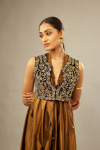 Golden olive silk long free size dress with asymmetric hem and side pockets, paired with navy blue silk velvet short jacket with light gold dori embroidery all-over the jacket.
