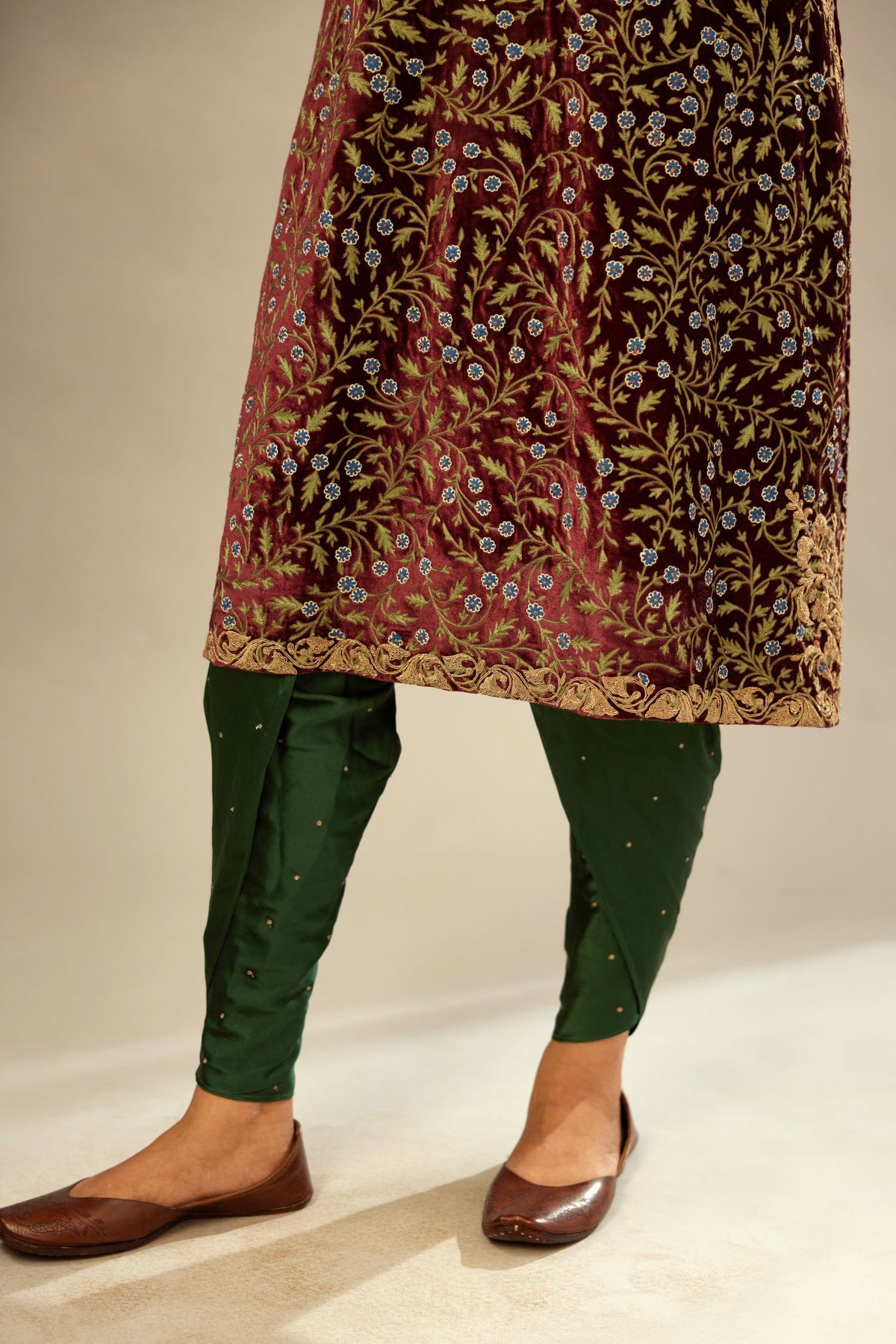 Maroon A-line silk velvet fully jaal embroidered kurta set, detailed with golden dori embroidery
