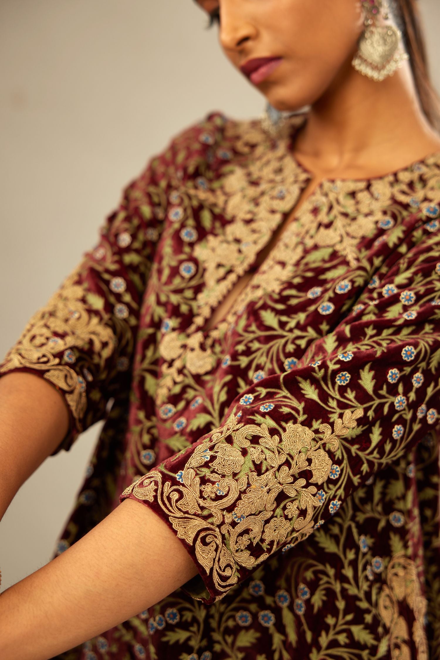 Maroon A-line silk velvet fully jaal embroidered kurta set, detailed with golden dori embroidery
