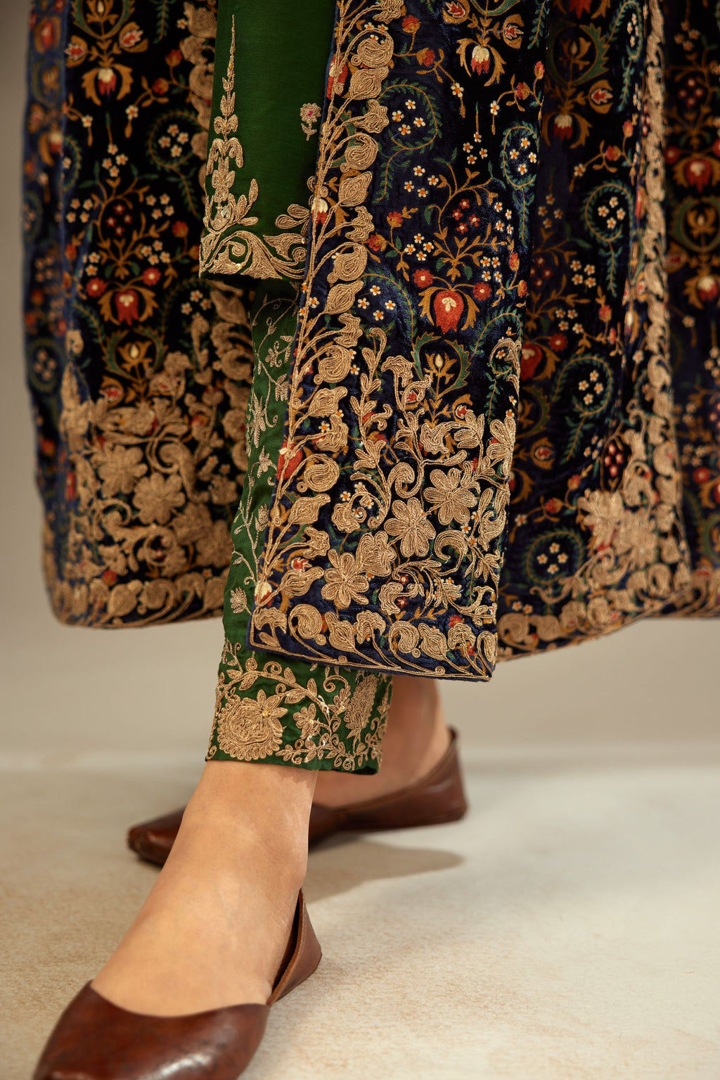 Navy blue silk velvet ankle length front open jacket with fully silk thread jaal embroidery and detailed with light gold dori embroidery.