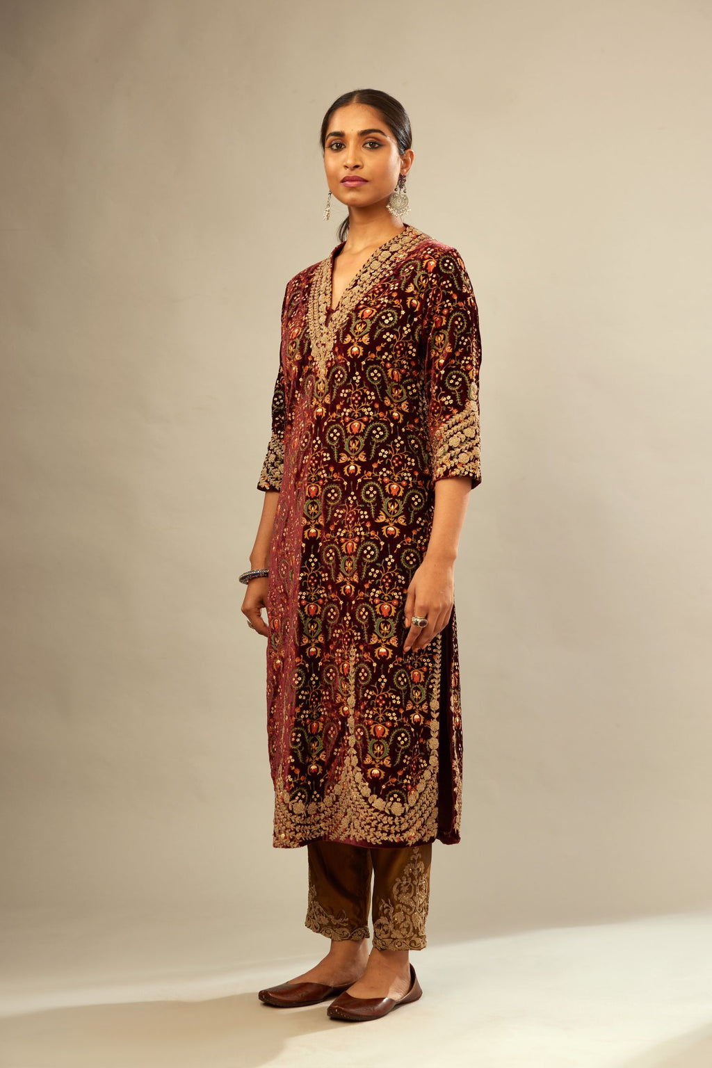 Maroon silk velvet lined kurta set with heavy jaal embroidery all over the kurta and ornamented with dori embroidery at neck, sleeves, side slits and hem.