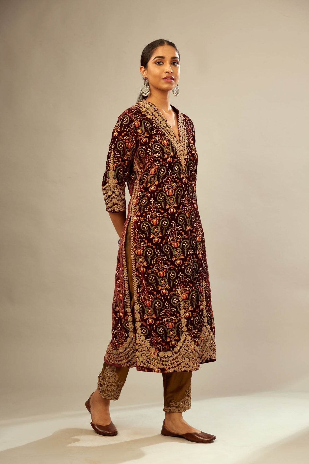 Maroon silk velvet lined kurta set with heavy jaal embroidery all over the kurta and ornamented with dori embroidery at neck, sleeves, side slits and hem.