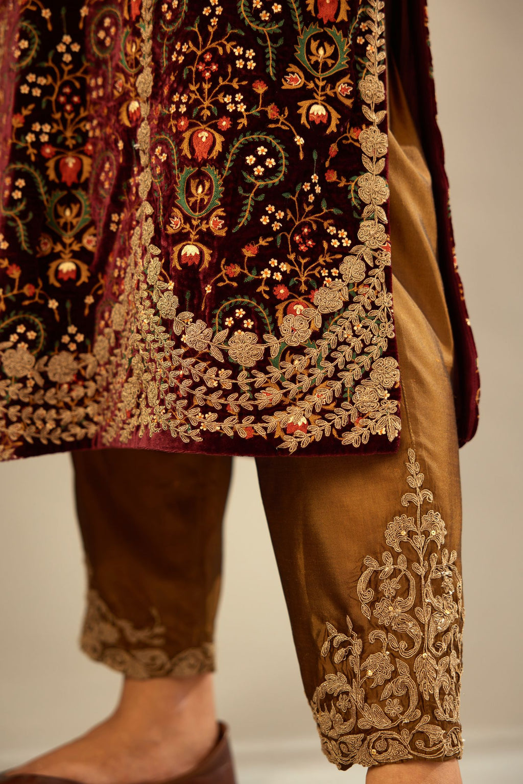 Maroon silk velvet lined kurta set with heavy jaal embroidery all over the kurta and ornamented with dori embroidery at neck, sleeves, side slits and hem.