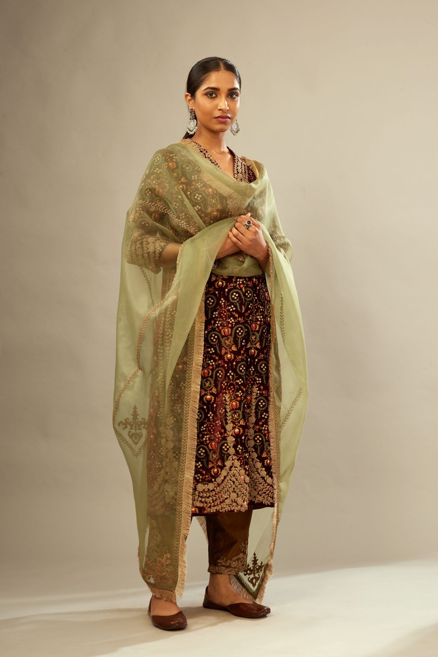Maroon silk velvet lined kurta set with heavy jaal embroidery all over the kurta and ornamented with dori embroidery at neck, sleeves, side slits and hem.