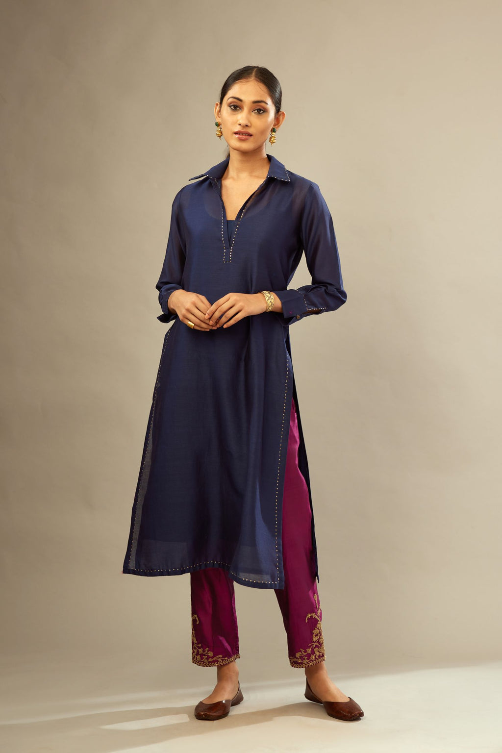Navy blue silk chanderi kurta set with a shirt collar neckline and full sleeves, detailed with gold sequin work.