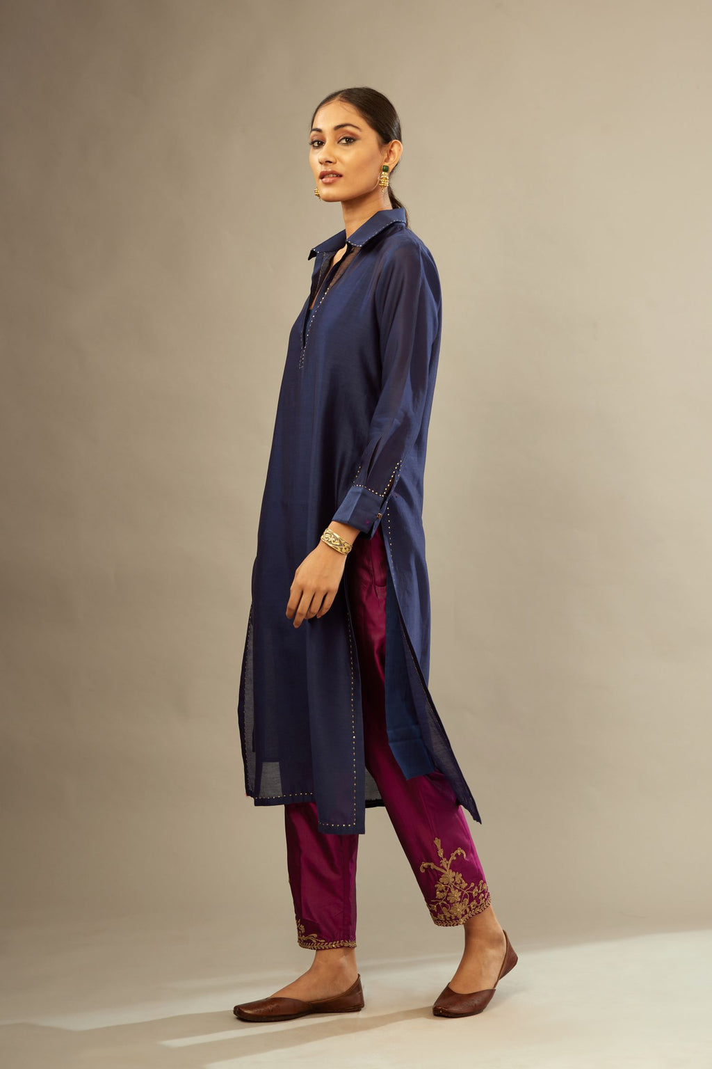 Navy blue silk chanderi kurta set with a shirt collar neckline and full sleeves, detailed with gold sequin work.