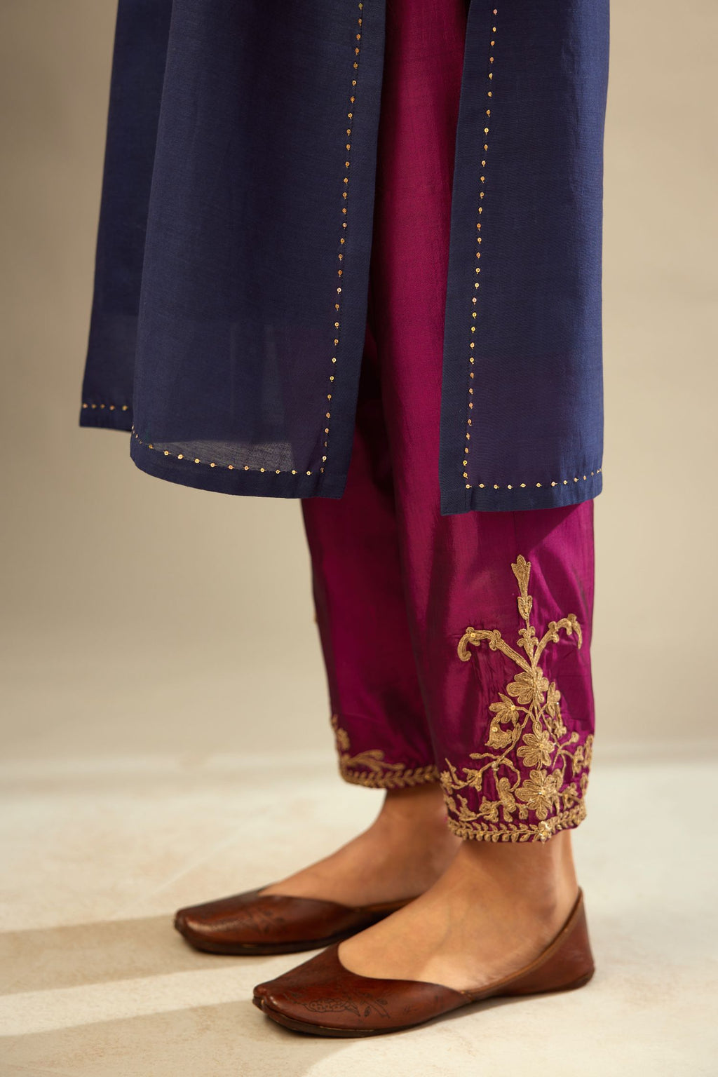 Green long silk chanderi front open sleeveless jacket set with gold dori embroidery detailing, highlighted with gold sequin work.