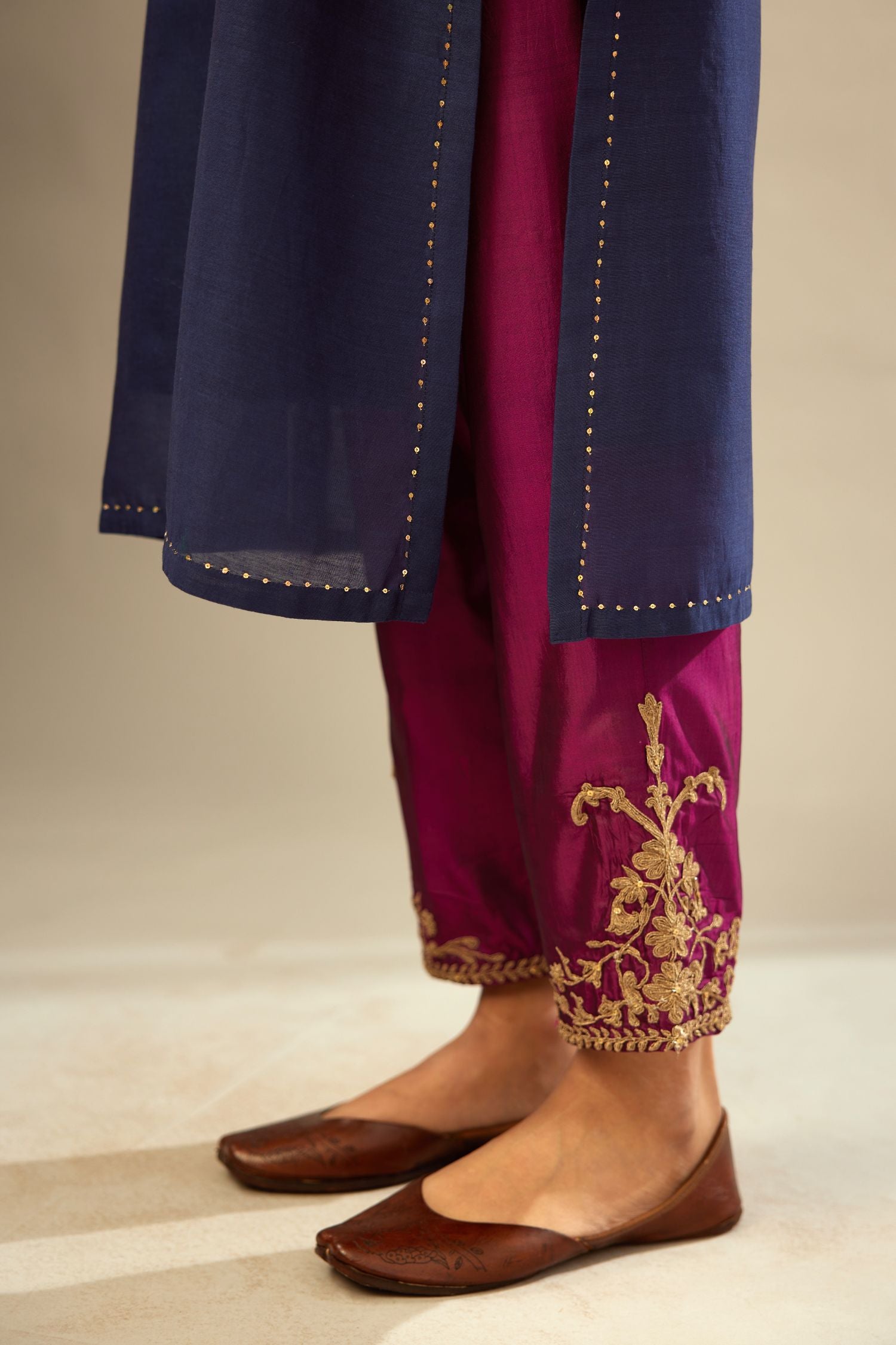 Green long silk chanderi front open sleeveless jacket set with gold dori embroidery detailing, highlighted with gold sequin work.