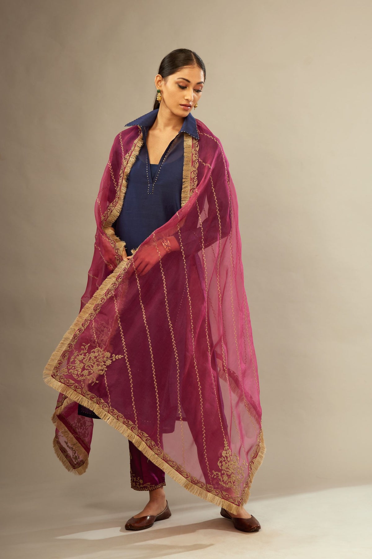 Fuchsia silk organza dupatta with dori embroidery border at the edges and diagonal zari embroidered lines all-over the dupatta.