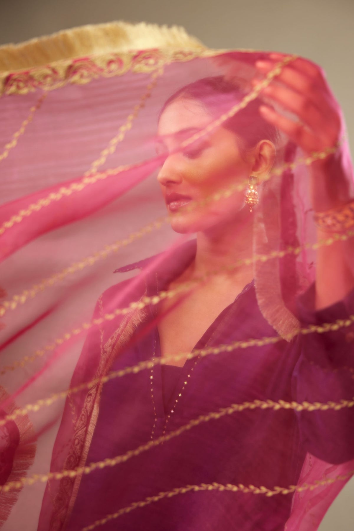 Fuchsia silk organza dupatta with dori embroidery border at the edges and diagonal zari embroidered lines all-over the dupatta.