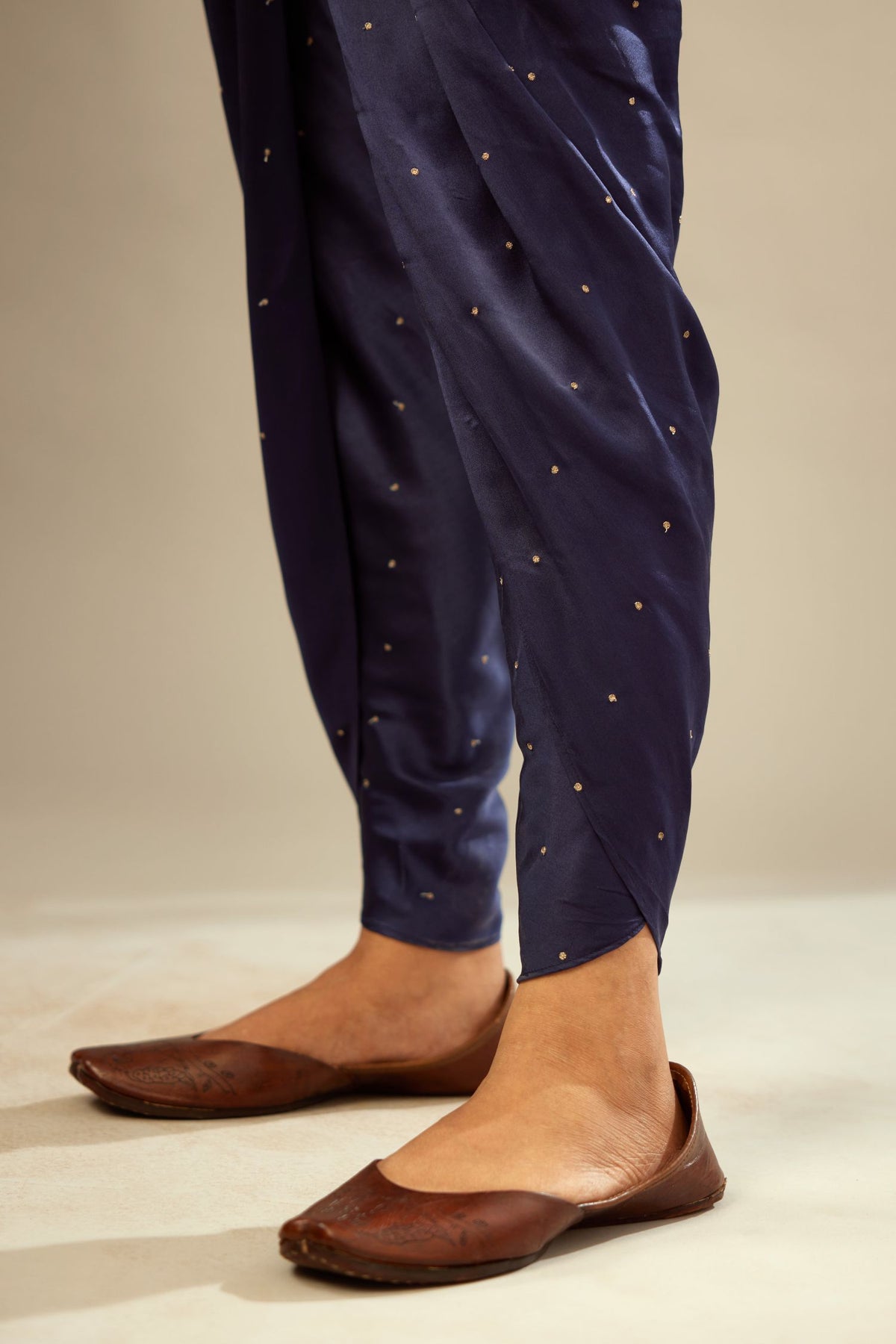 Navy blue silk dhoti with all over small flower embroidery.