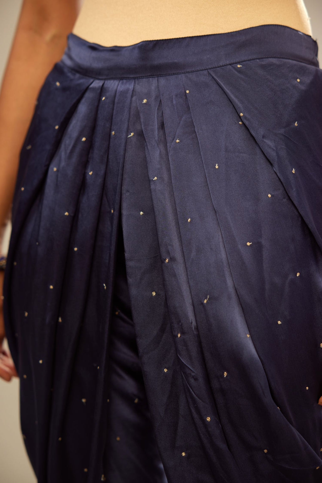 Navy blue silk dhoti with all over small flower embroidery.