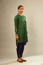 Green silk short kurta set with high-low hem with rounded edges, highlighted with gold zari embroidery.