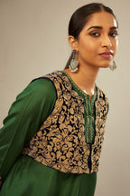 Green silk short kurta set with high-low hem with rounded edges, highlighted with gold zari embroidery.