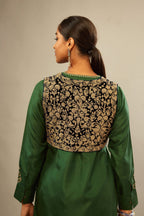 Green silk short kurta set with high-low hem with rounded edges, highlighted with gold zari embroidery.