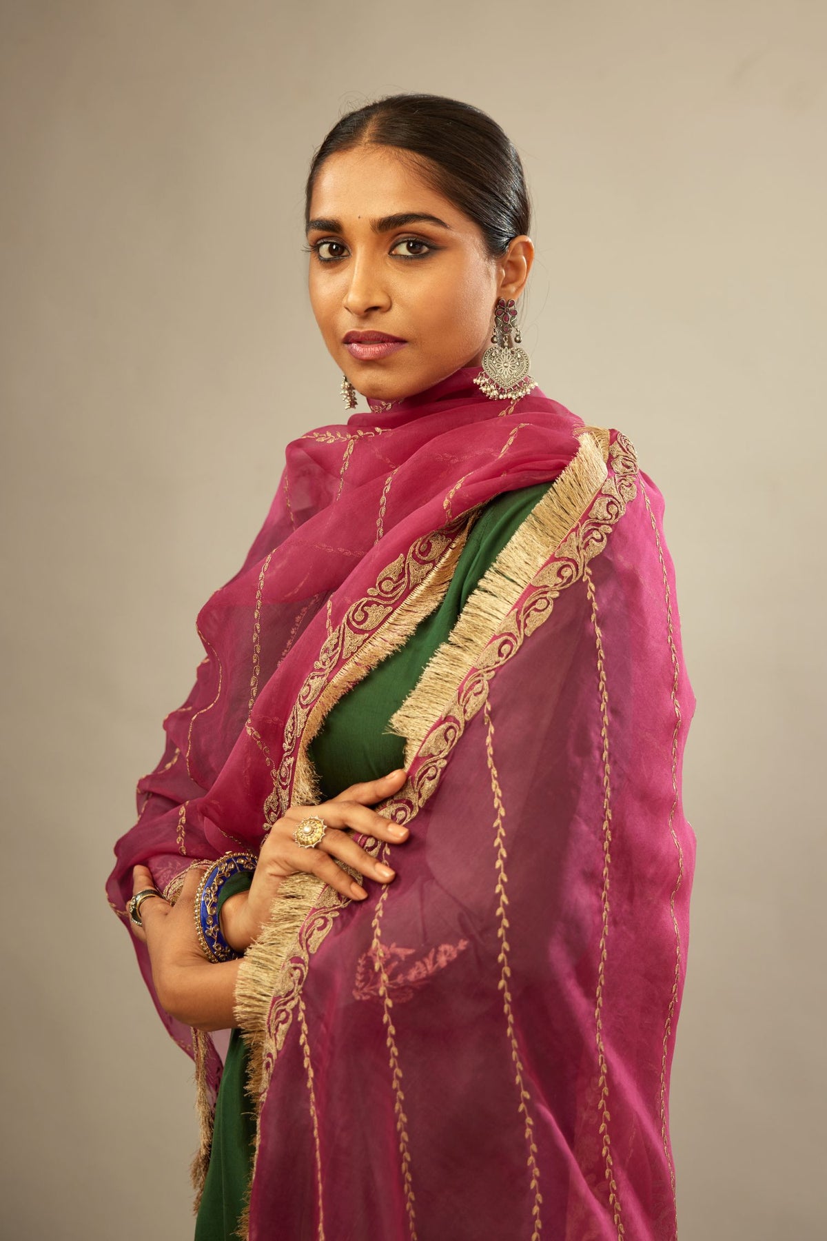 Fuchsia silk organza dupatta with dori embroidery border at the edges and diagonal zari embroidered lines all-over the dupatta.