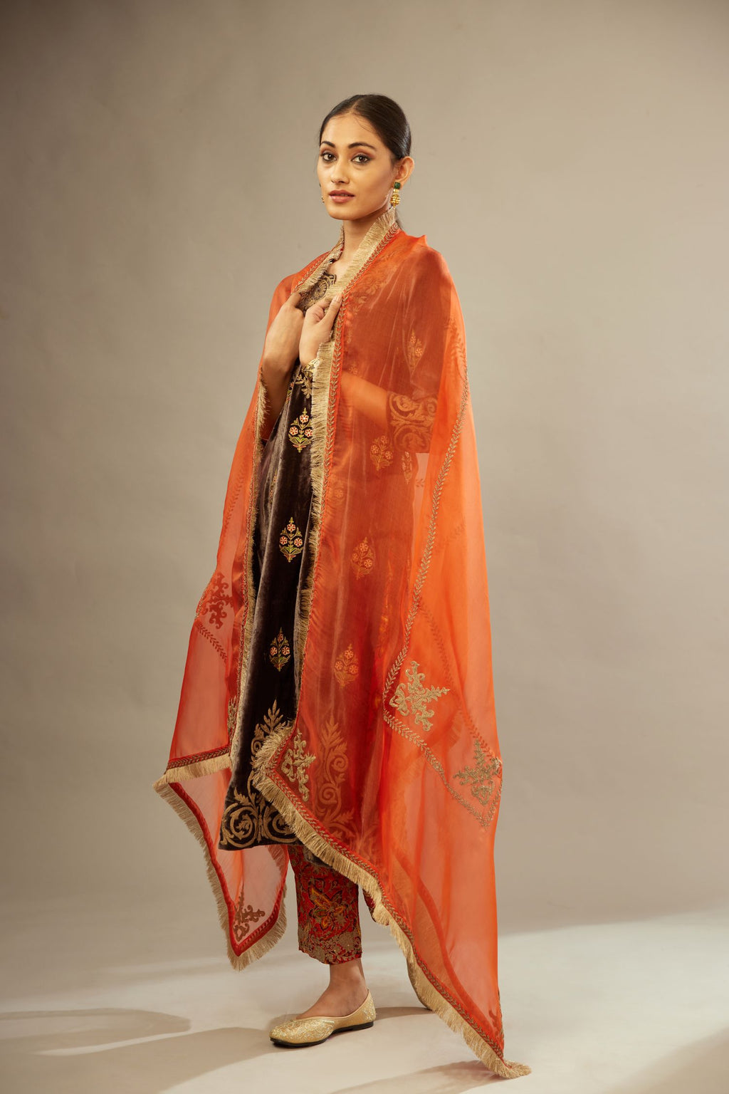 Orange silk organza dupatta detailed with all-over light gold dori embroidery.