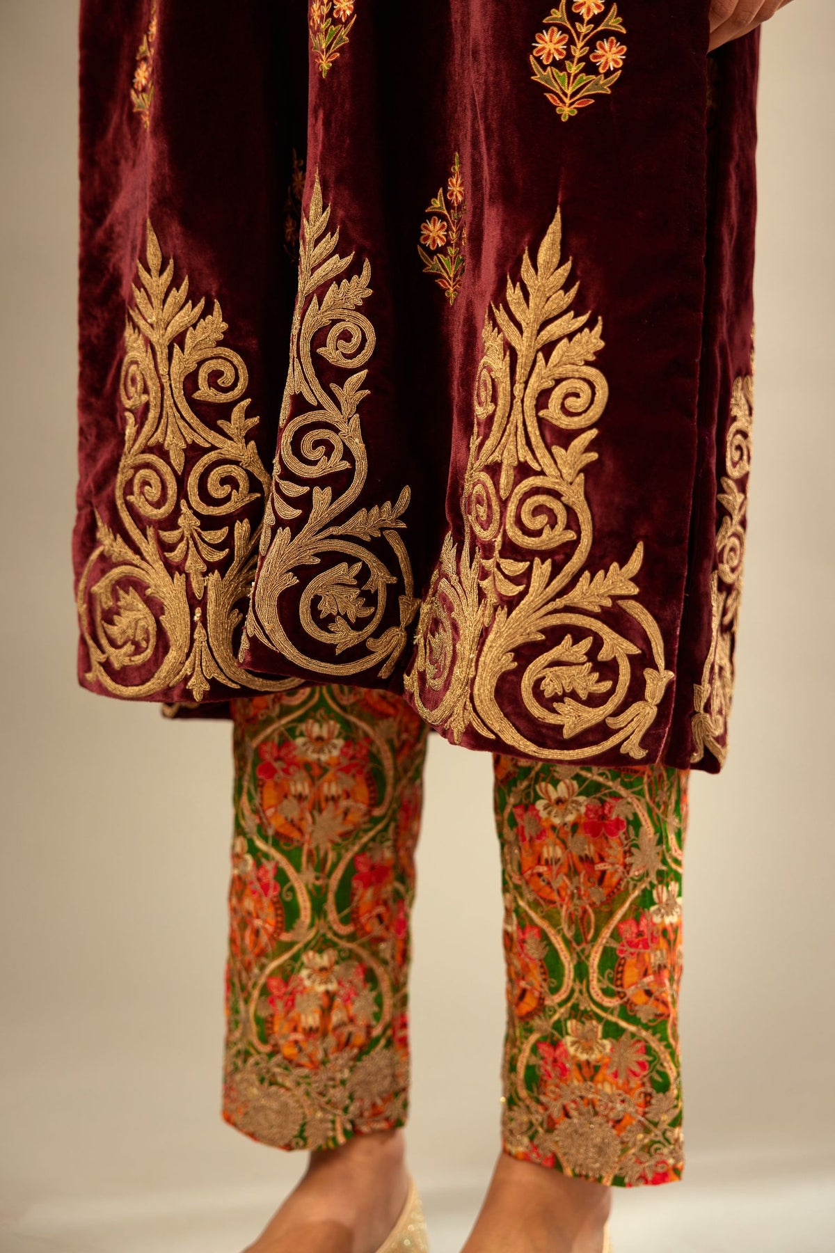Marron silk velvet lined kurta set with light gold dori embroidery and contrast colored boota all-over the kurta.