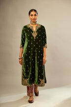 Green silk velvet kurta set with small embroidered zari buties all-over the kurta and detailed with dori embroidery at neck, sleeves, side slits and hem.