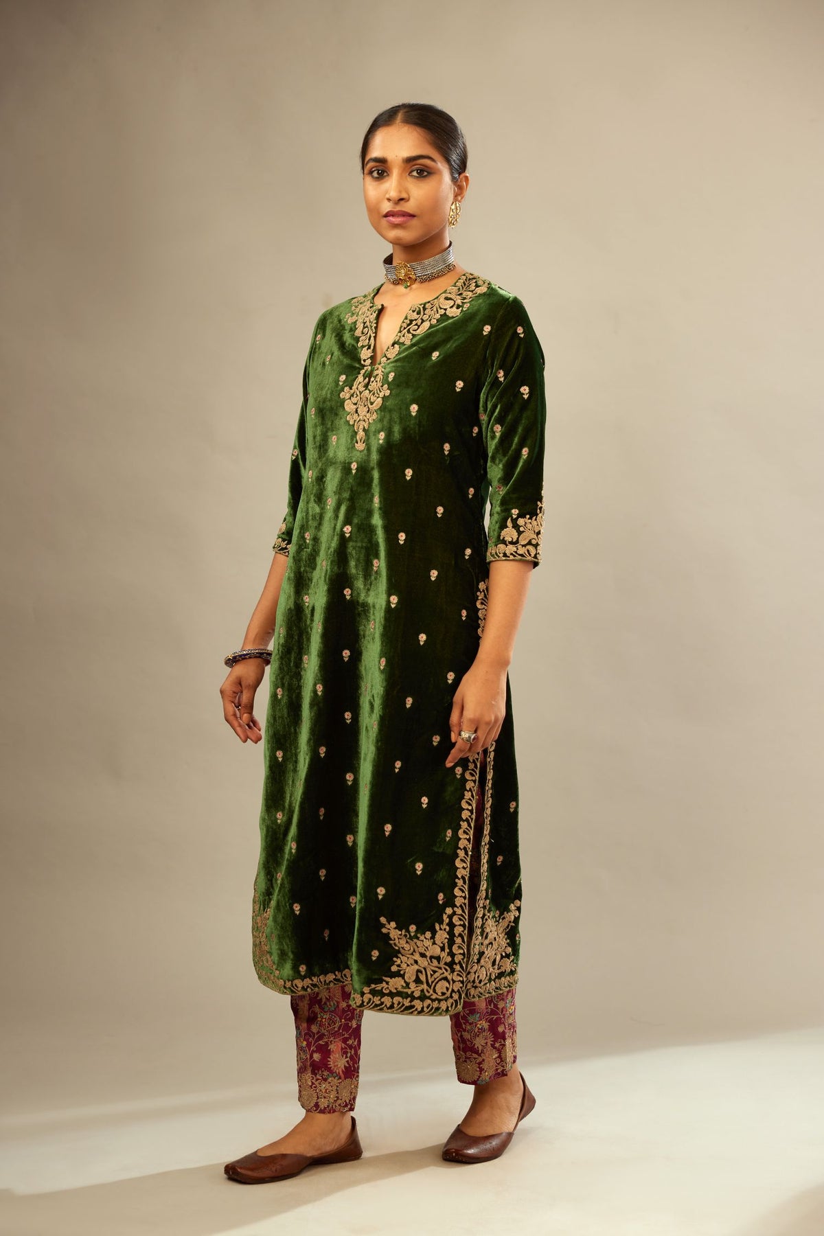 Green silk velvet kurta set with small embroidered zari buties all-over the kurta and detailed with dori embroidery at neck, sleeves, side slits and hem.